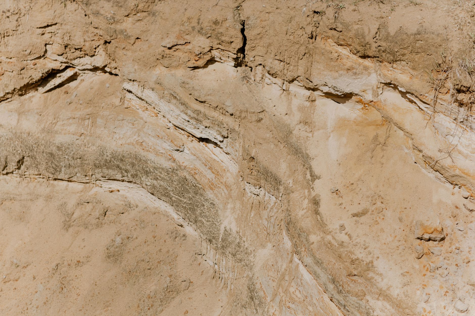Dry and rugged cliff face showcasing nature's erosion patterns.
